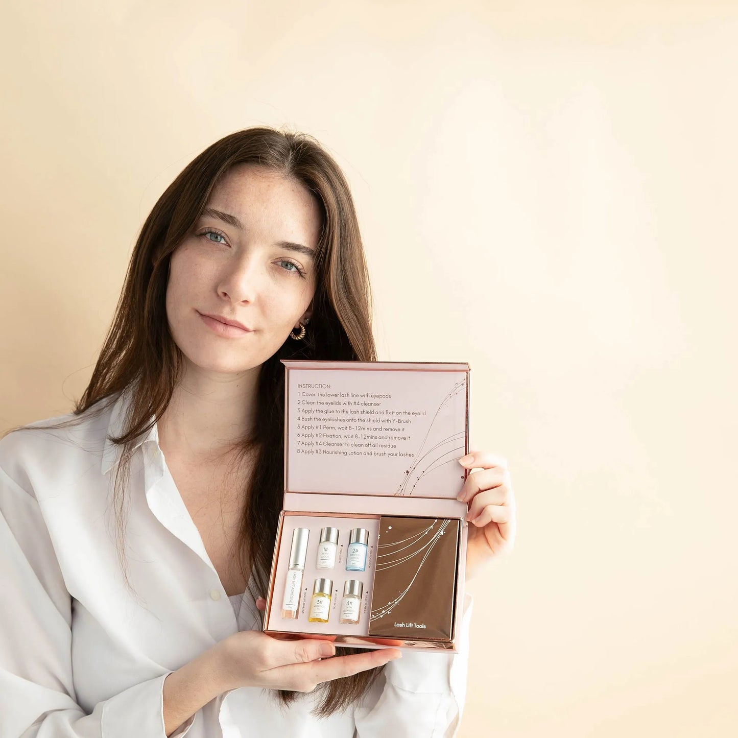 Woman holding the MiyLash Lash Lift Kit, highlighting the included instructions and complete set for at-home lash lifting and care.